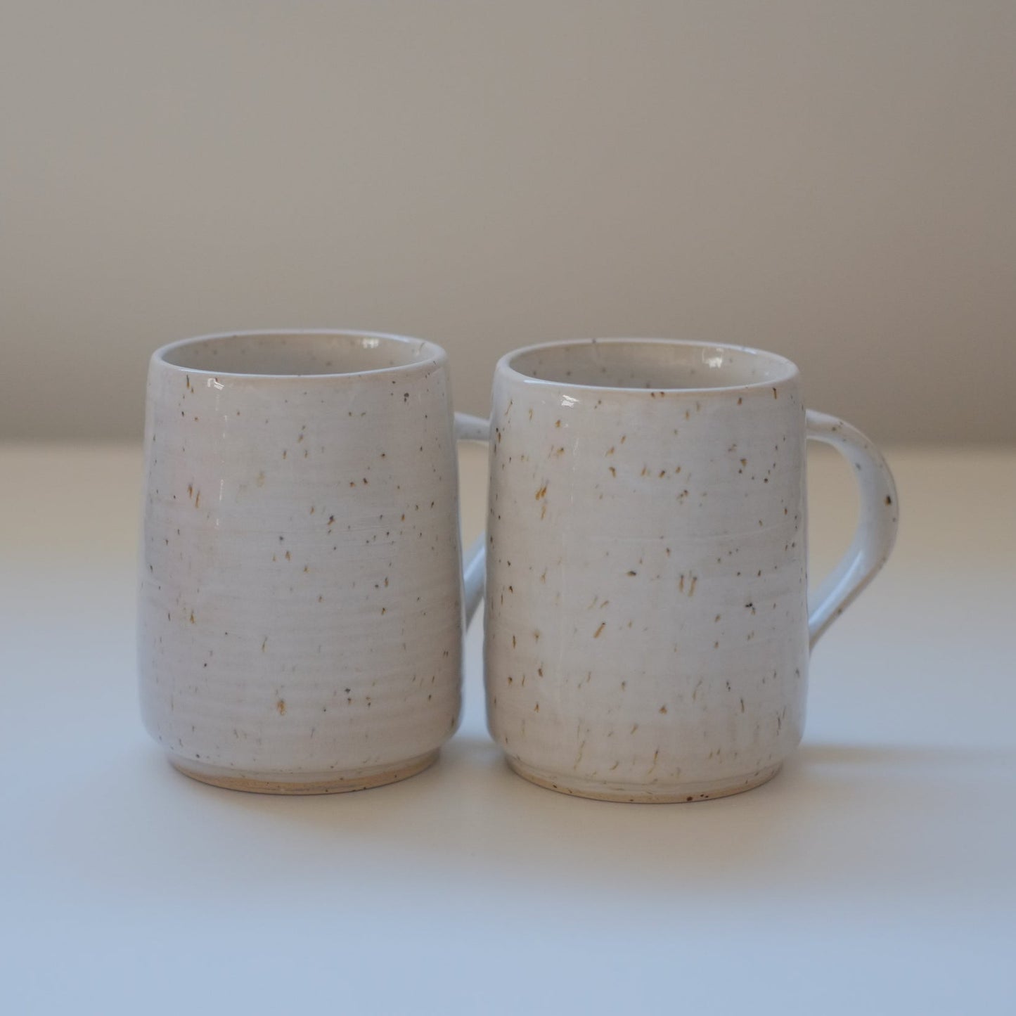 Pair of small speckled white mugs