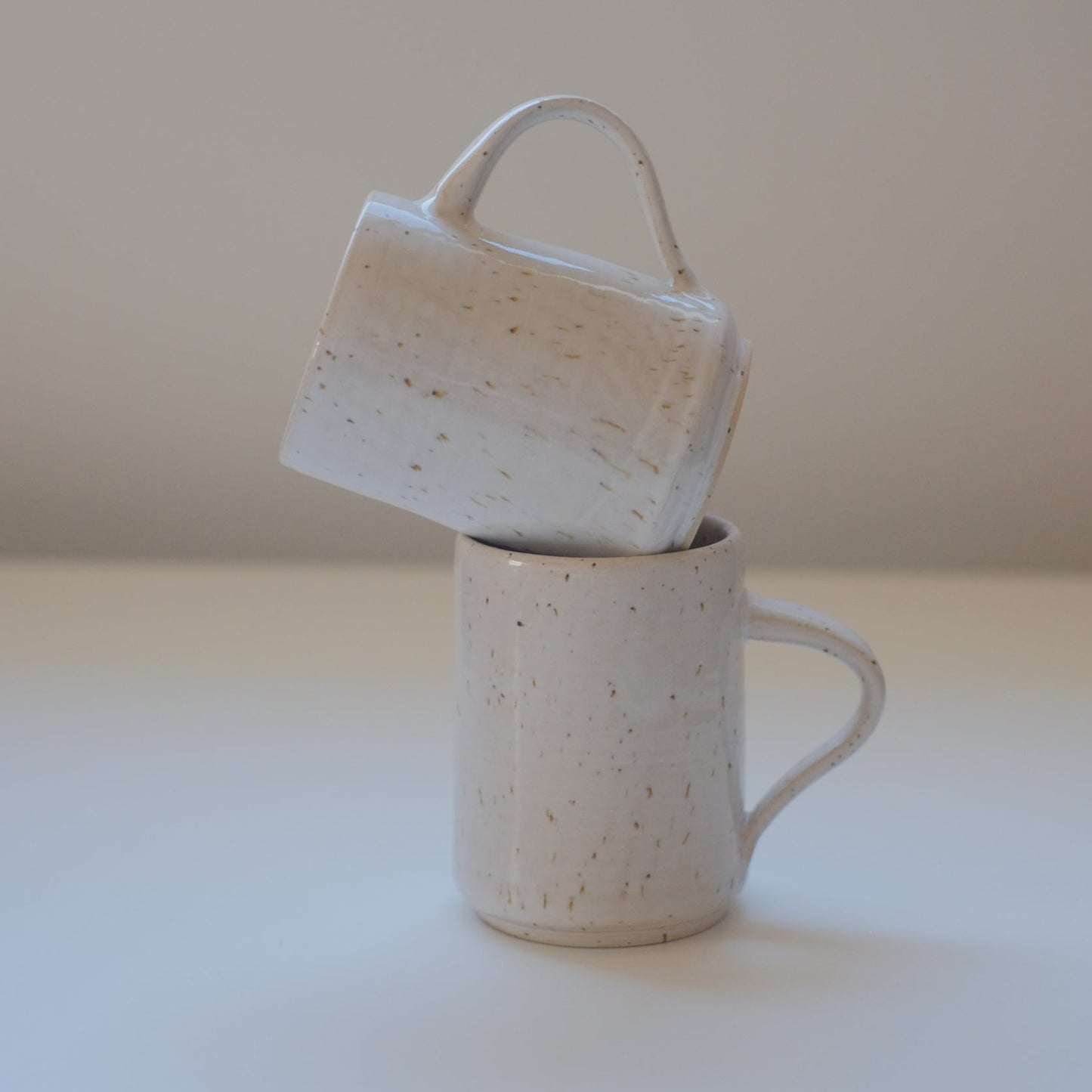 Set of small speckled white mugs