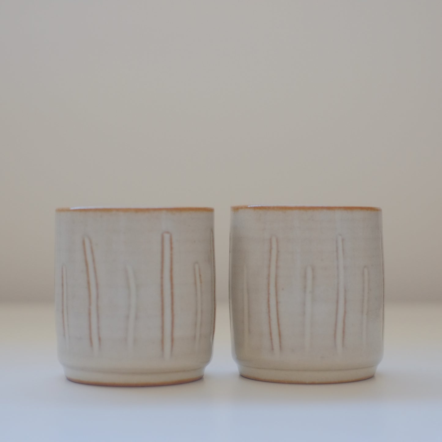 Two X-Small Cream/Tan Tumblers